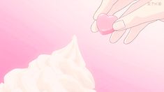 a hand reaching for a pink heart shaped object