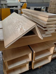 several pieces of plywood are stacked on top of each other in a workshop area