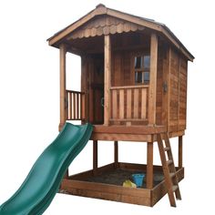 a wooden play house with a green slide in the foreground and a white background