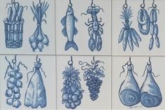 nine blue and white tiles with different types of food hanging from hooks on the wall