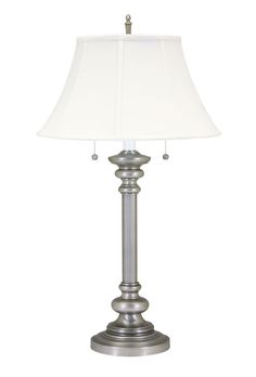 a silver lamp with a white shade on it