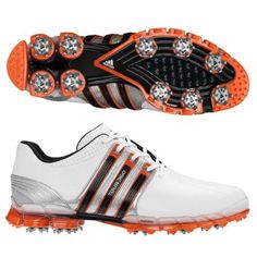 a pair of white and orange golf shoes