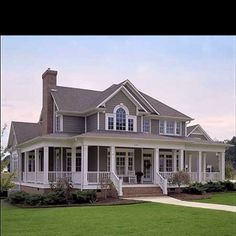 a large house sitting on top of a lush green field