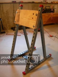 a wooden frame sitting on top of a hard wood floor in a room with tools