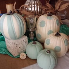 some blue and white pumpkins sitting on a table