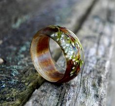 a wooden ring with flowers painted on it