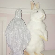 two stuffed animals sitting on top of a shelf next to each other in a room