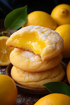 a stack of lemon cookies sitting on top of each other next to some lemons