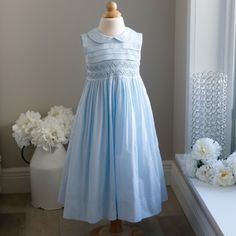 This Strasburg Style Is Stunning! This Pastel Blue Sundress Has A Hand Smocked Bodice With Blue And White Embroidered Rosettes And Embroidered White Scalloped Horizontal Details. The Upper Bodice Is Adorned With 3 French Tucks- True To Strasburg Tradition! A Peter Pan Collar Completes This Classic Look. A Sash Ties In A Bow In The Back. 100% Cotton Lawn. Pass This Dress On To Future Generations. Like New-Perfect Condition. Classy And Oh-So-Sweet!!!! Contrasting Sister Dresses Available In Apple Blue Sundress, Sisters Dress, Hand Smock, Smocked Dress, Apple Green, Pan Collar, Peter Pan Collar, Pastel Blue, Kids' Dresses