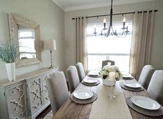 the dining room table is set with place settings