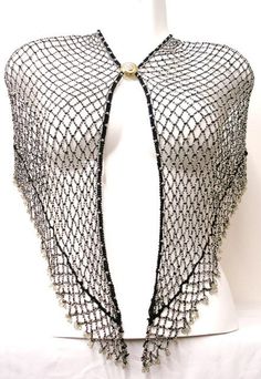 This shawl can be worn also as a wrap. The length of the shawl from hook to eye is approx. 33 inches, and there is a 4 inch extension on both sides.Using these extensions, you can move the eye and hook to suit your waist measurements. When worn on the hips, the center length is 9 inches in the center and 6 inches towards the eye and the hook (Excluding fringes) .All descriptions are approximate or estimate only. Shawl With Arm Holes, Silver Shawl, Black One Size Shawl Wrap, Spider Web Shawl, Elegant One-size Cape Shawl, Black Shear Shawl, 1920’s Shawl, Sequin Bra, Sequin Vest