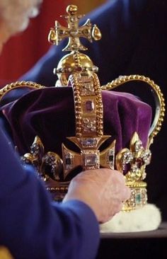 an older woman holding a crown in her hands