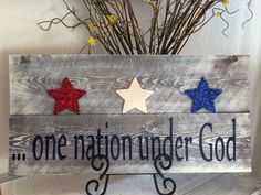 a wooden sign that says one nation under god with three stars on it and the words, one nation under god