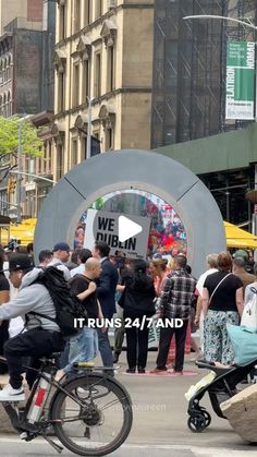 a group of people walking and riding bikes on a city street