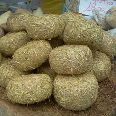 a pile of hay sitting on top of a wooden table