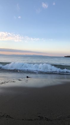 the waves are coming in to the shore at sunset or sunrise, and there is no image here