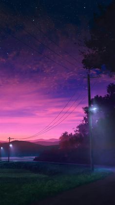 the night sky is lit up by street lamps and power lines, with mountains in the distance