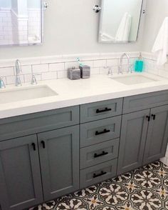 a bathroom with two sinks and mirrors in it