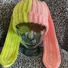 a knitted hat and scarf on top of a mannequin's head