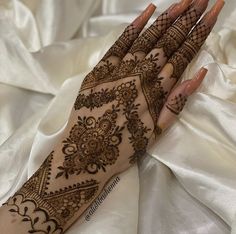 a woman's hand with henna on it