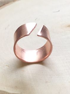 "Solid copper adjustable ring, simple copper ring. This ring has been hand hammered and shaped and is slightly adjustable which really helps if your fingers swell sometimes but you still want to wear your favorite ring. This ring is a sturdy band of copper with a diagonal opening in the ring which not only gives the ring an interesting appeal it also gives the ring function and allows you to gently adjust your ring fit. This ring is also available in Sterling Silver which will come with a .925 H Unique Open Copper Ring Jewelry, Bronze Copper Open Ring Jewelry, Bronze Copper Open Ring, Adjustable Copper Metal Ring Jewelry, Copper Open Ring Jewelry, Minimalist Adjustable Copper Ring, Rose Gold Wide Band Open Ring For Gift, Rose Gold Open Ring In Copper, Rose Gold Copper Open Ring