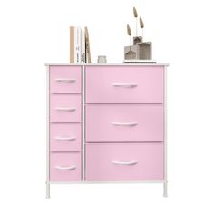 a pink chest of drawers with books on top