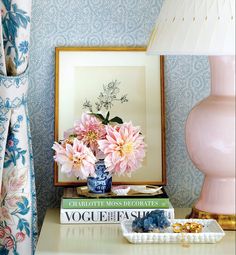 an image of a vase with flowers in it on a table next to a lamp