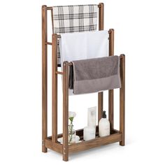 a wooden towel rack with two towels on it and one folded up in the middle