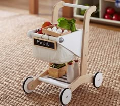 a toy wagon filled with food on top of a rug