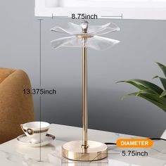 a table lamp with a white dragonfly on it and measurements for the base height