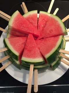 slices of watermelon and toothpicks on a plate