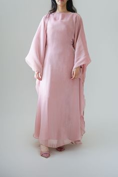 Indulge in our new Luxury silk Kaftan, part of our newest collection. A beautiful rose quartz shade that would look perfect for any occasion. The kaftan can be tied with the inner belt or styled with a loose fit (as shown in pictures) can be worn from a size S - XL. This Kaftan comes with a under layer dress Width: 60cm  This design comes in three shades; Rose Quartz, Cream, Lavender. * model is 5 ft 6 * material:  Premium silk Organza * fabric can differ due to lighting and also production whil Pink Wedding Kaftan For Eid, Pink Dabka Kaftan For Eid, Pink Maxi-length Thobe For Eid, Pink Maxi Length Thobe For Eid, Long Pink Abaya For Eid, Eid Evening Maxi Length Thobe, Festive Elegant Long Dress Abaya, Festive Elegant Maxi Length Thobe, Festive Elegant Long Abaya