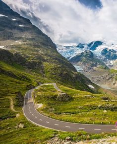 a car driving down a road in the mountains