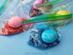 three plastic bags filled with different colored candies on top of a blue tablecloth