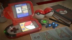 an electronic device sitting on top of a wooden table next to two eggs and other items