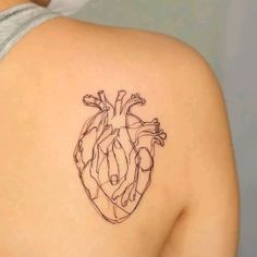 a heart tattoo on the back of a woman's shoulder