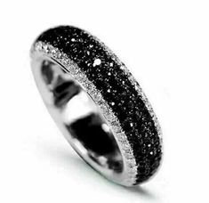 a white gold ring with black and white diamonds