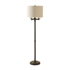 a floor lamp with a white shade on it's base and a black metal pole