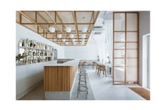 an empty bar with stools and bottles on the shelves