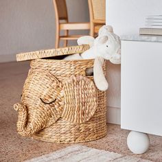 a teddy bear sitting in a basket next to a radiator