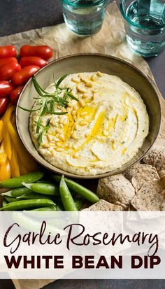 garlic rosemary white bean dip in a bowl surrounded by vegetables