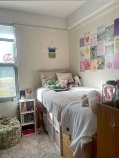 a bedroom with a bed, dresser and window