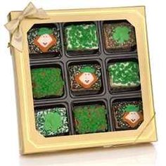 a box filled with cupcakes covered in green frosting and topped with st patrick's day decorations