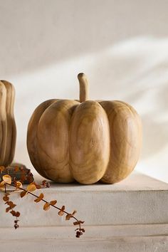 three wooden pumpkins sitting next to each other