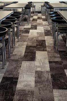 an empty restaurant with tables and chairs lined up on the floor, in front of a large window