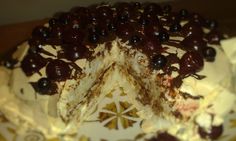 a cake with white frosting and chocolate toppings