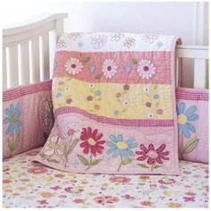 a baby crib bed with flowers on it