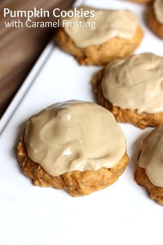 pumpkin cookies with caramel frosting on a white plate