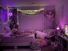 a bed room with a neatly made bed and purple lights