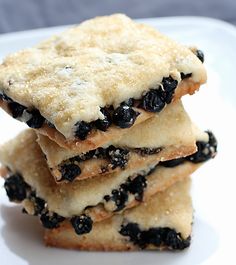 three blueberry shortbreads stacked on top of each other in a white plate